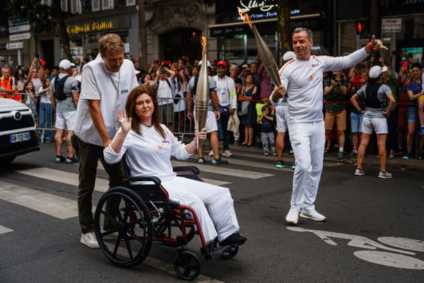 AFP journalists Christina Assi and Dylan Collins, injured in Lebanon, carry the Olympic flame