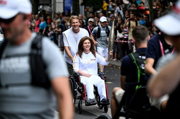 AFP journalists Christina Assi and Dylan Collins, injured in Lebanon, carry the Olympic flame